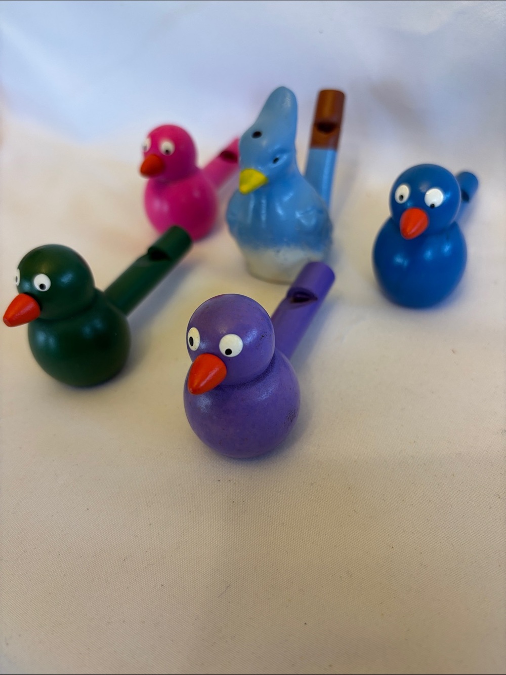 SET OF 4 COLORFUL WOODEN WHISTLES BLUE,GREEN ,PURPLE ,PINK &1 BLUE CLAY WHISTLE - Picture 2 of 8